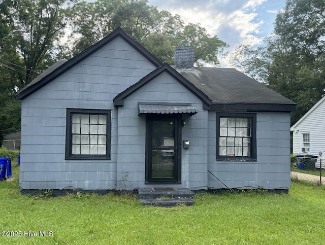 bungalow-style home with a front lawn