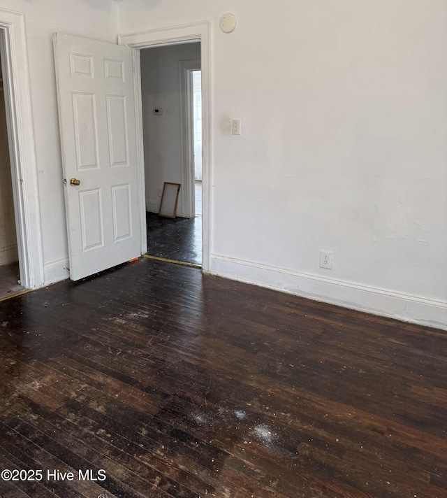 spare room featuring dark hardwood / wood-style floors