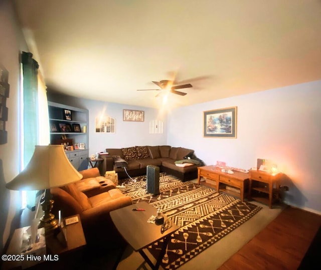 living room featuring hardwood / wood-style flooring and ceiling fan