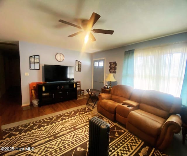 living room with ceiling fan and wood finished floors