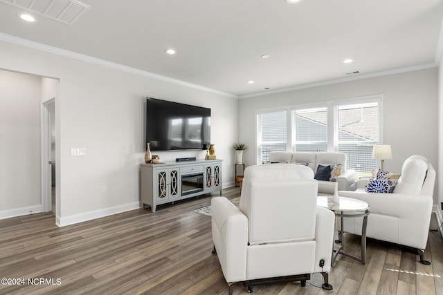 living room with hardwood / wood-style flooring and crown molding