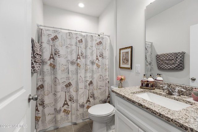 bathroom featuring vanity, curtained shower, tile patterned floors, and toilet