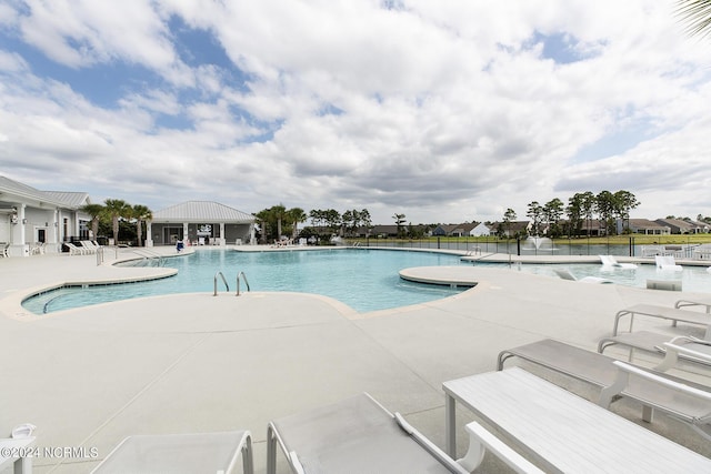 view of swimming pool with a patio