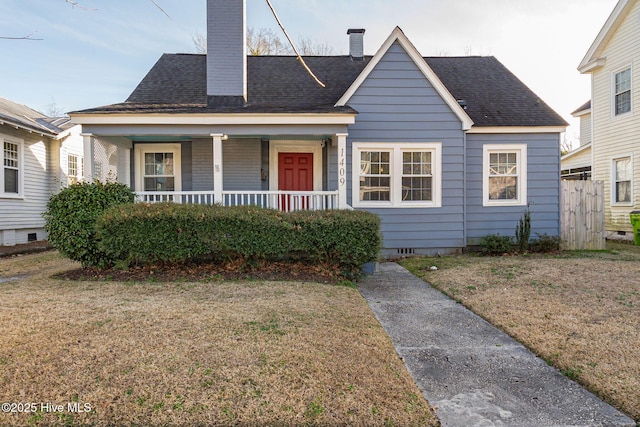 bungalow-style home with a porch and a front yard