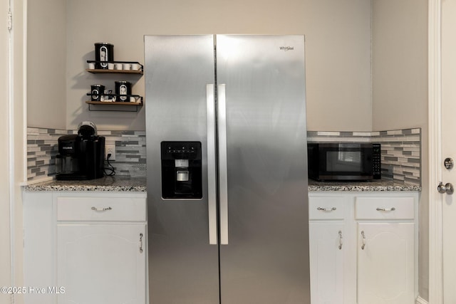 kitchen featuring backsplash, light stone countertops, white cabinets, and stainless steel refrigerator with ice dispenser