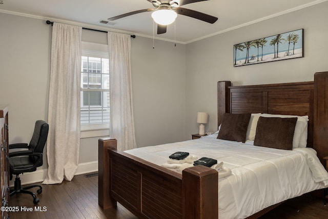 bedroom with crown molding, dark wood-type flooring, and ceiling fan