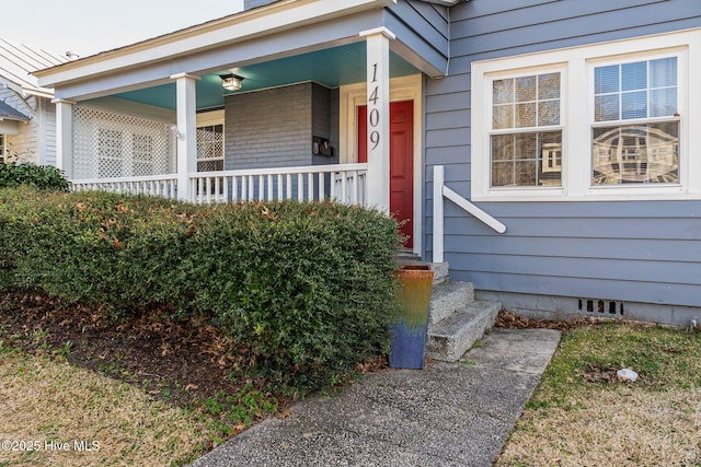 doorway to property featuring a porch