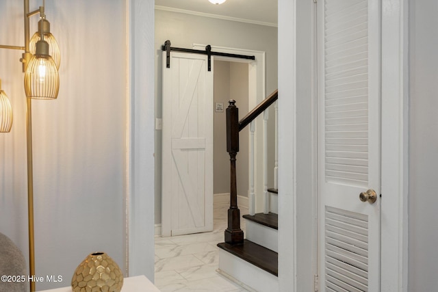 stairway featuring crown molding and a barn door