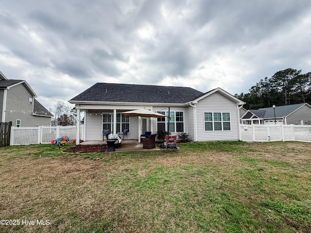 back of property featuring a yard and a patio area