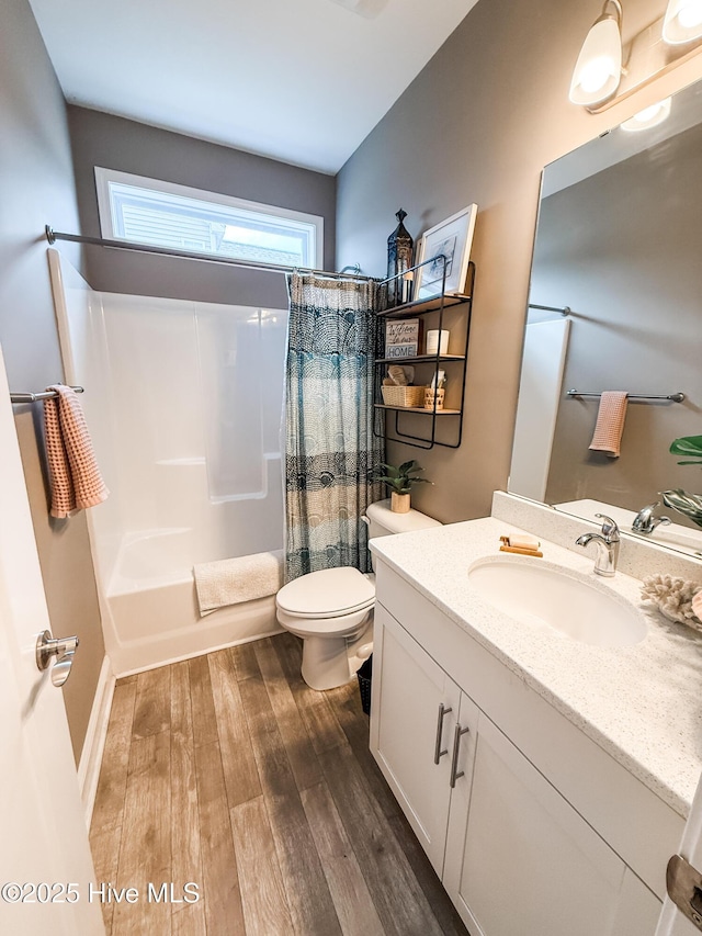 full bathroom featuring shower / bath combination with curtain, wood-type flooring, toilet, and vanity