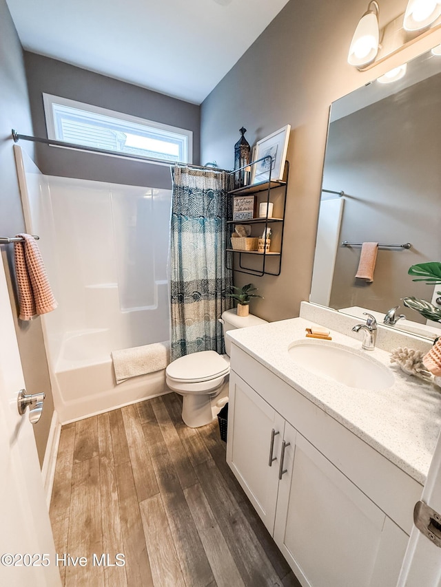 full bathroom with shower / tub combo, vanity, toilet, and hardwood / wood-style floors