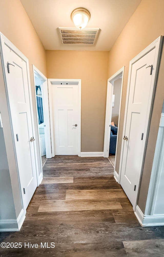 hall with dark hardwood / wood-style flooring