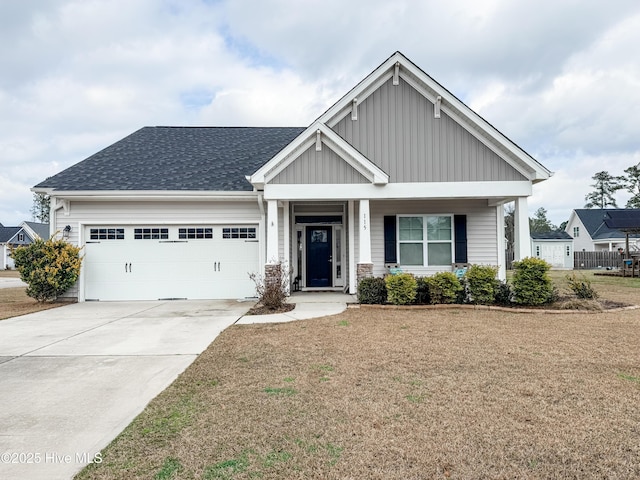 craftsman inspired home featuring a garage, a front lawn, and a porch