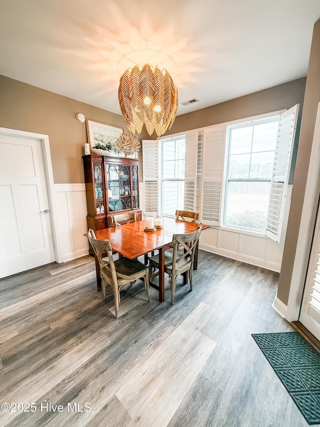 dining room featuring an inviting chandelier and wood-type flooring