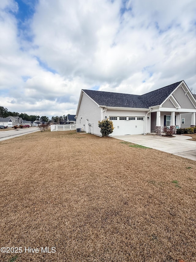 view of front of house with a garage and a front lawn