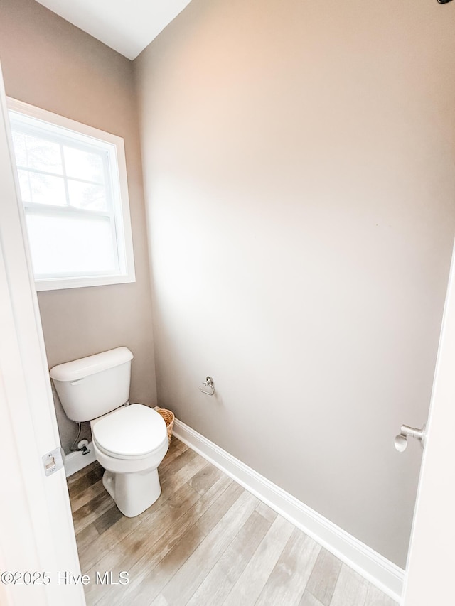 bathroom featuring hardwood / wood-style flooring and toilet