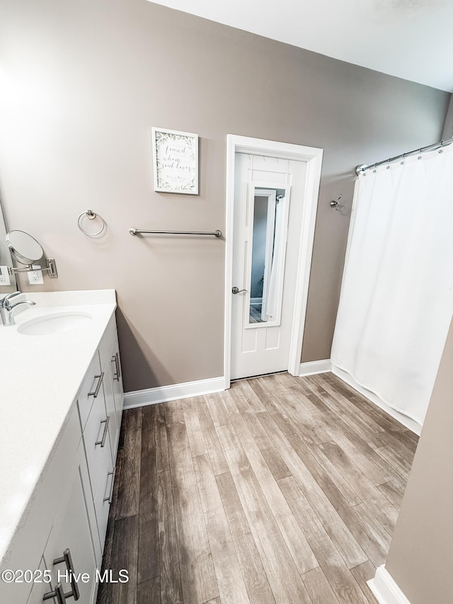 bathroom with vanity and hardwood / wood-style floors