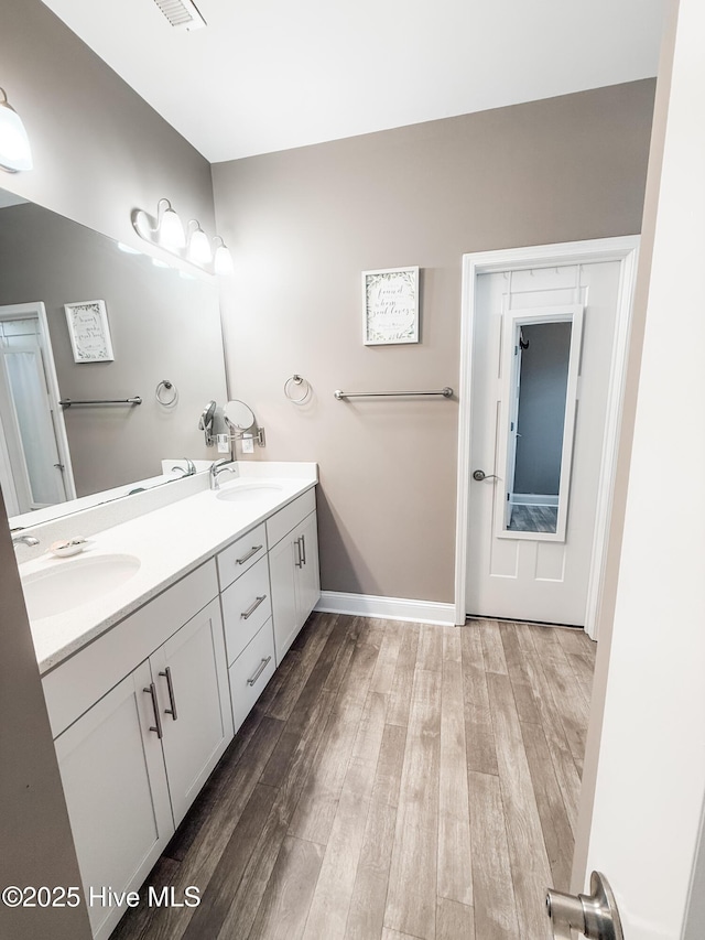 bathroom featuring vanity and hardwood / wood-style flooring