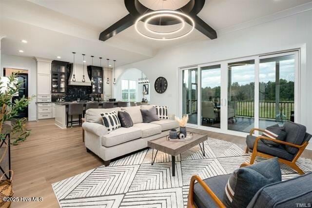 living room featuring light hardwood / wood-style floors and beamed ceiling