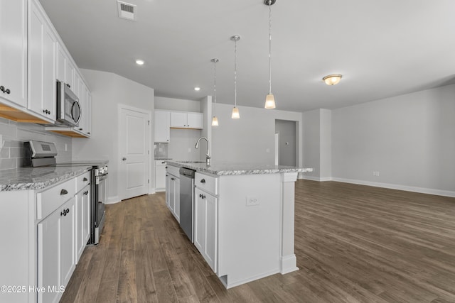 1204 Calabash Station Blvd NW, Calabash, NC 28467 - kitchen with stainless steel appliances, a sink, dark wood-type flooring, baseboards, and white cabinets