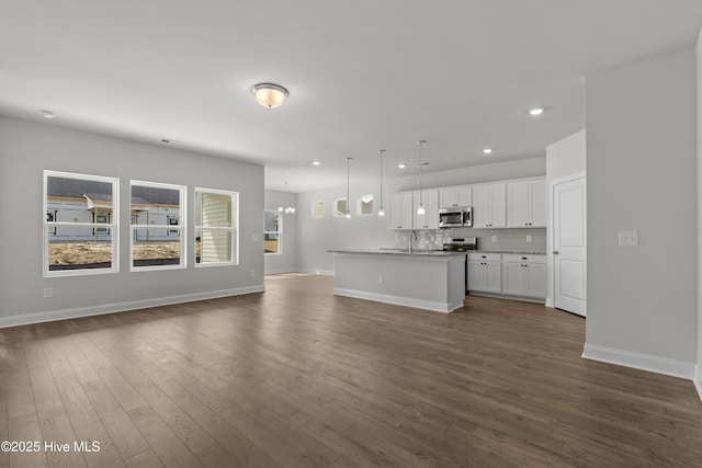 1204 Calabash Station Blvd NW, Calabash, NC 28467 - unfurnished living room featuring recessed lighting, dark wood-style flooring, baseboards, and a sink