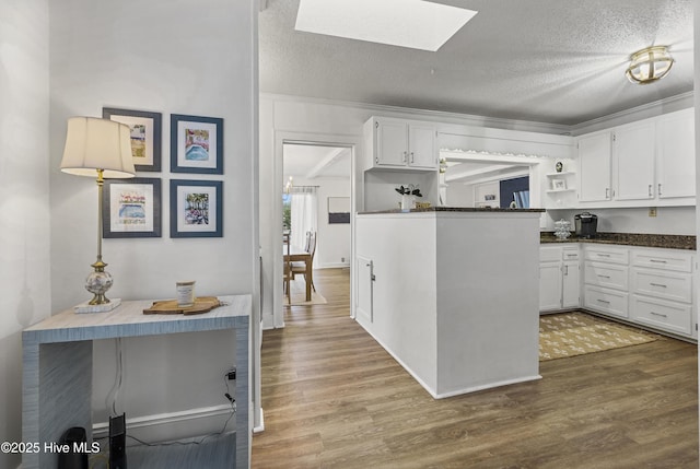 3401 Taylor St, Morehead City, NC 28557 - kitchen with white cabinetry, hardwood / wood-style floors, and a textured ceiling