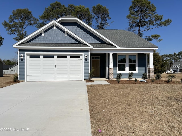 craftsman-style house featuring driveway, a shingled roof, and an attached garage