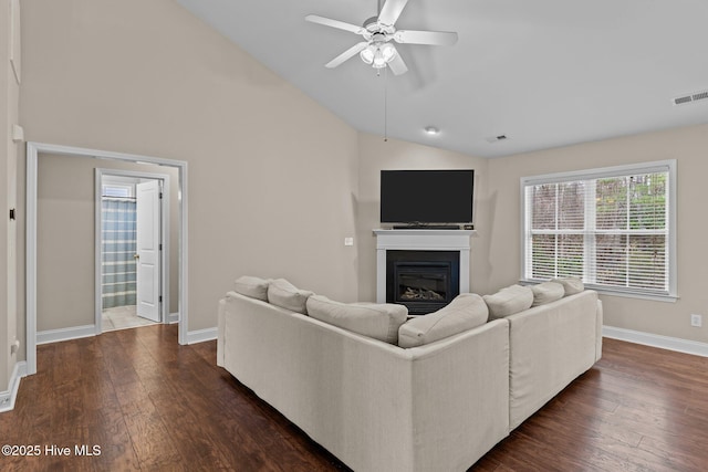 living room with lofted ceiling, dark wood-type flooring, and ceiling fan