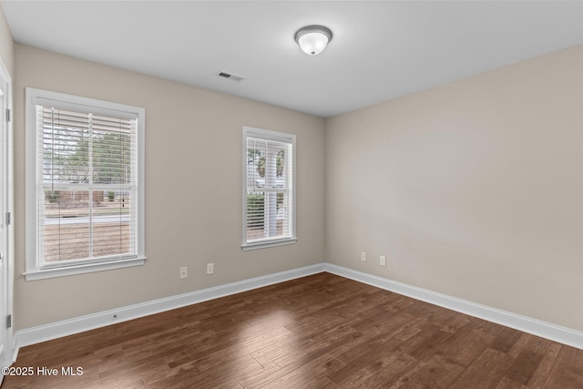 spare room featuring dark hardwood / wood-style floors