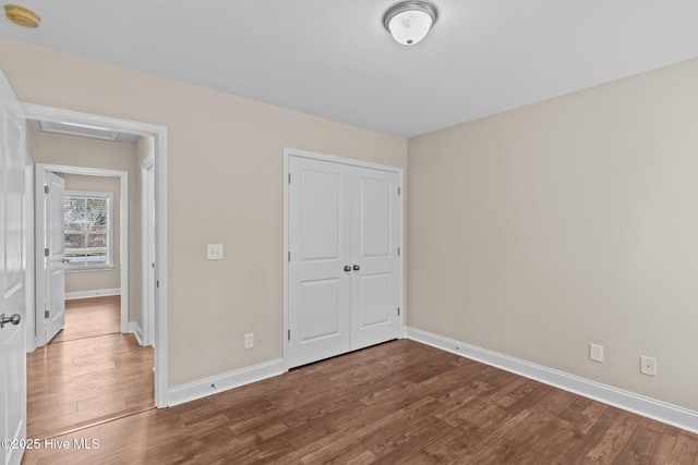 unfurnished bedroom with hardwood / wood-style floors and a closet