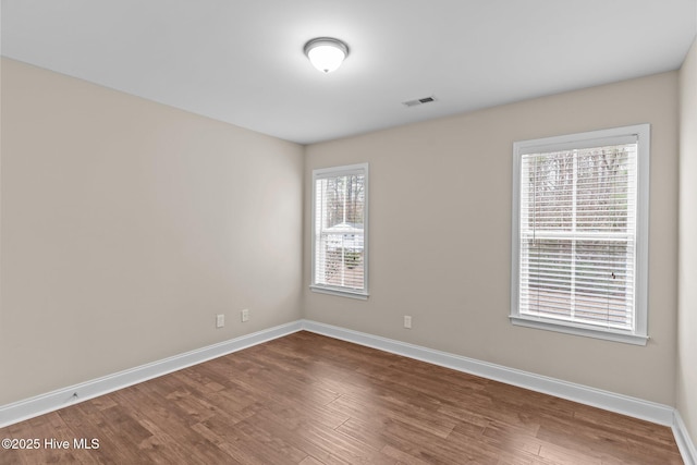 spare room featuring wood-type flooring