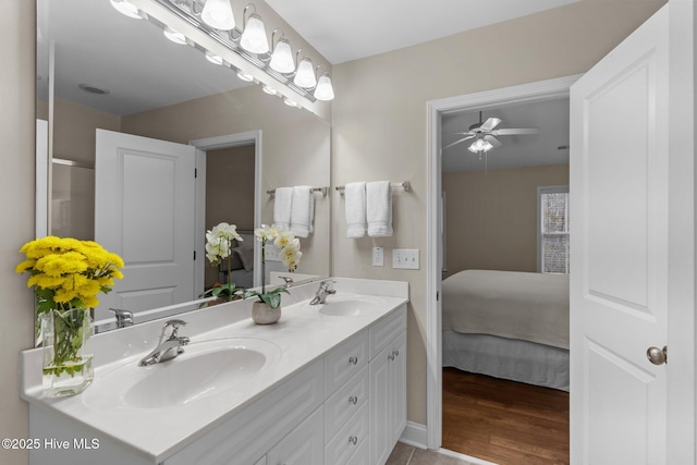 bathroom with ceiling fan, vanity, and wood-type flooring