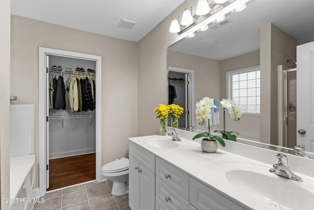 full bathroom featuring tile patterned floors, toilet, independent shower and bath, and vanity