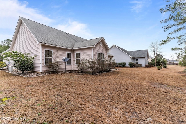 rear view of house featuring a lawn