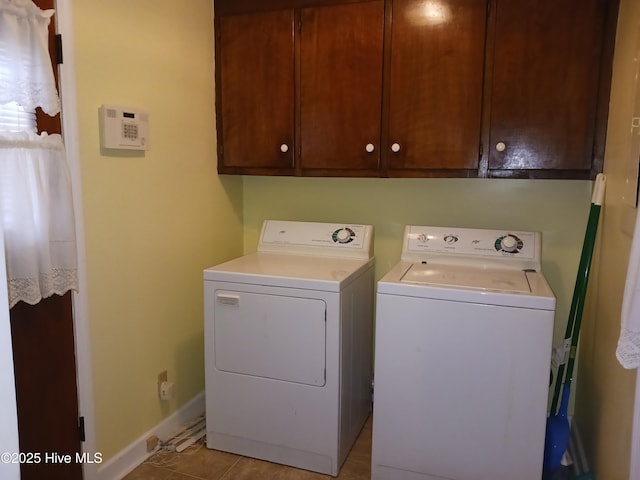 laundry room with cabinets and washing machine and clothes dryer