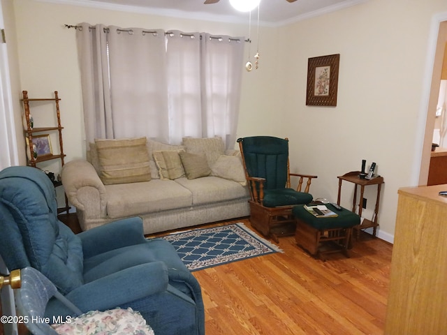 living room featuring ornamental molding, hardwood / wood-style floors, and ceiling fan