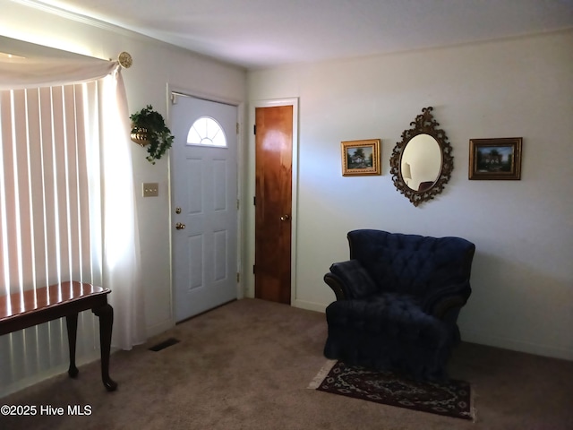 foyer featuring carpet flooring