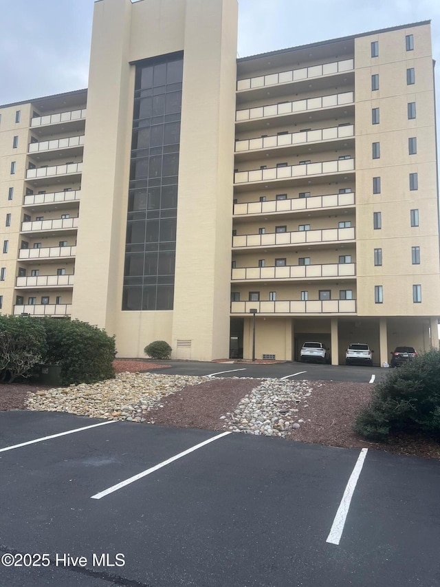 view of building exterior featuring uncovered parking