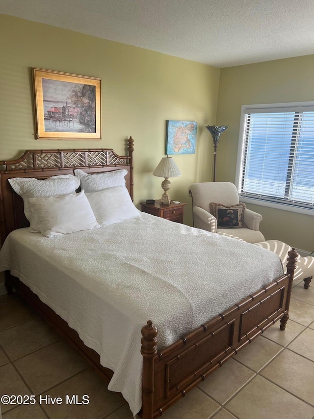 tiled bedroom with a textured ceiling