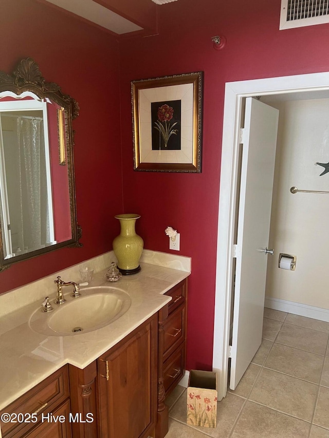 bathroom with baseboards, vanity, tile patterned floors, and visible vents