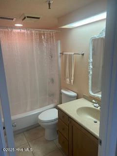 full bathroom featuring tile patterned floors, toilet, visible vents, shower / tub combo with curtain, and vanity
