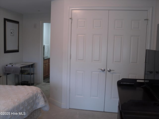 bedroom featuring connected bathroom and a closet