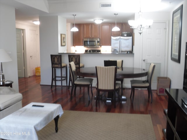 dining space with dark wood-type flooring