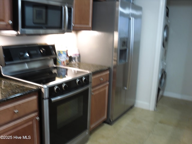 kitchen featuring dark stone countertops and black range with electric cooktop