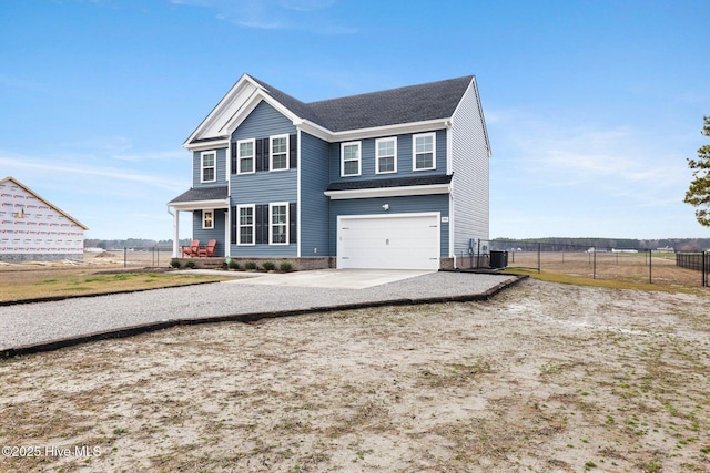 view of front of home with a garage and central air condition unit