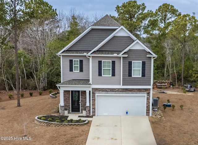 view of front facade with driveway, a garage, a shingled roof, stone siding, and central AC