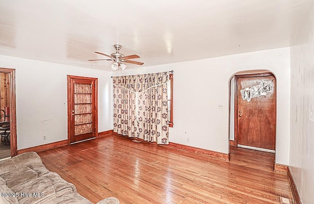 unfurnished living room with hardwood / wood-style flooring and ceiling fan