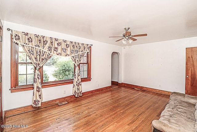 unfurnished living room with wood-type flooring and ceiling fan