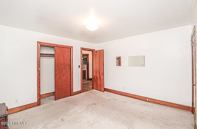 unfurnished bedroom with a closet and carpet