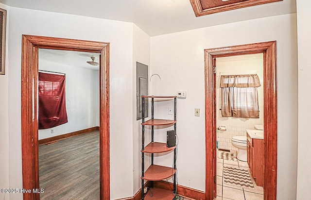 hallway with hardwood / wood-style floors and tile walls